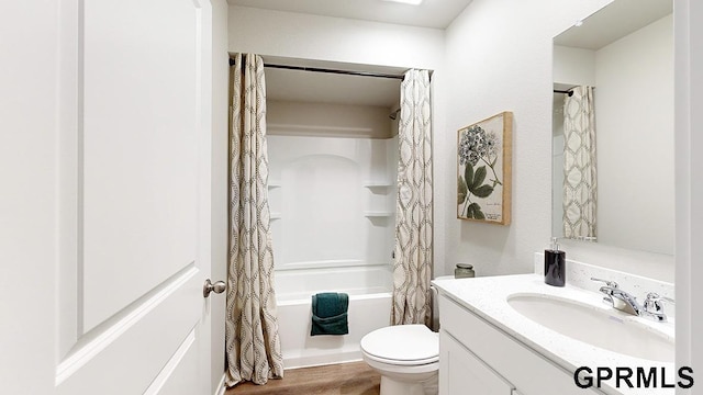 full bathroom featuring toilet, vanity, hardwood / wood-style flooring, and shower / tub combo with curtain