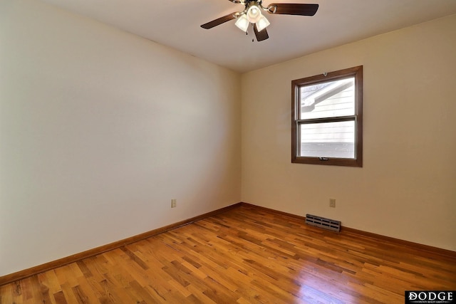 empty room with hardwood / wood-style floors and ceiling fan