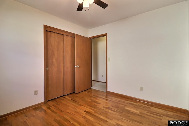 unfurnished bedroom featuring light hardwood / wood-style flooring, a closet, and ceiling fan