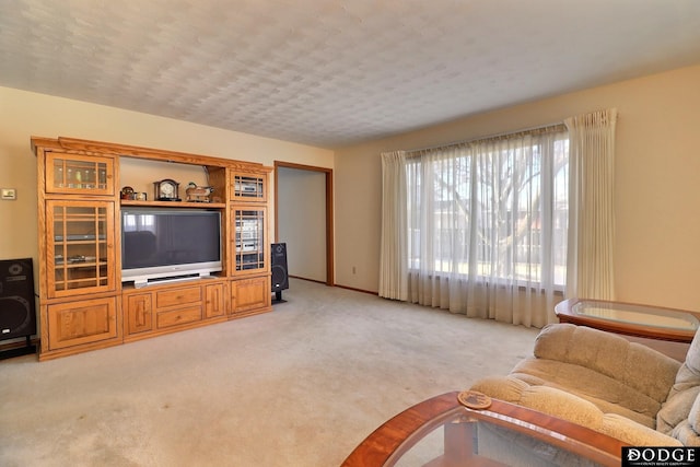 living room featuring light colored carpet and a textured ceiling