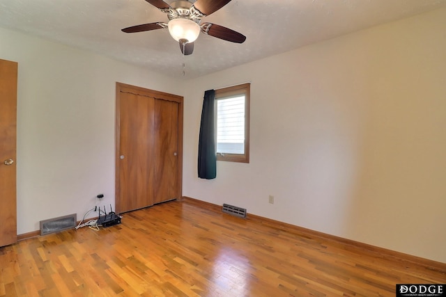 unfurnished bedroom with light hardwood / wood-style floors, a closet, and ceiling fan