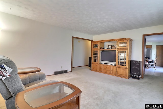 carpeted living room with a textured ceiling