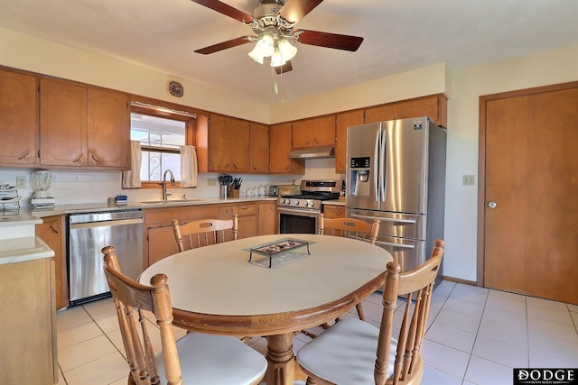 kitchen featuring ceiling fan, light tile patterned flooring, sink, and stainless steel appliances