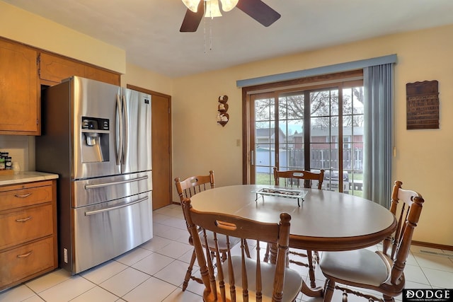 tiled dining space with ceiling fan