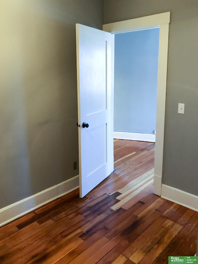 empty room with hardwood / wood-style flooring