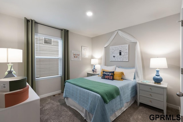 bedroom with dark colored carpet