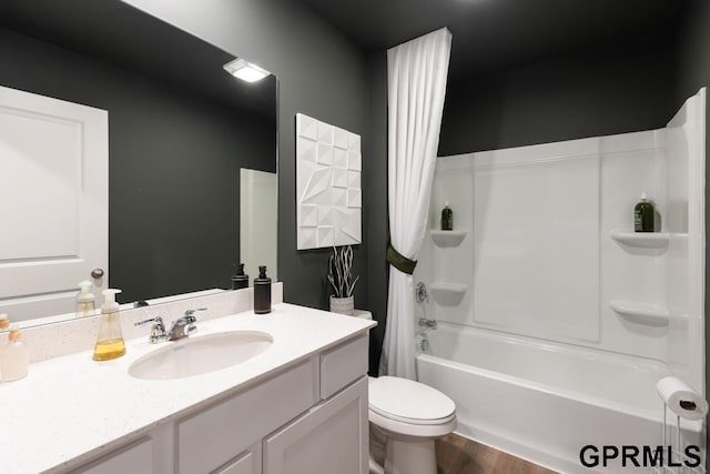 full bathroom featuring vanity, wood-type flooring, shower / tub combo, and toilet