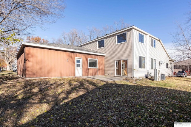 rear view of house featuring a patio and a lawn