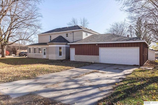 view of front of property with a front lawn and a garage