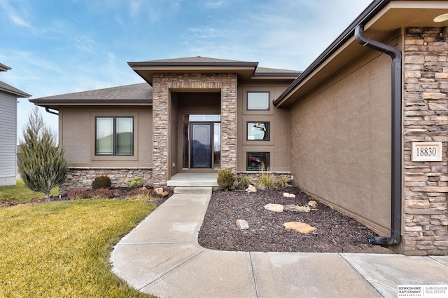 view of exterior entry featuring a yard