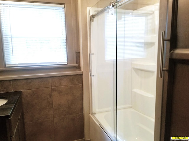 bathroom featuring vanity and combined bath / shower with glass door