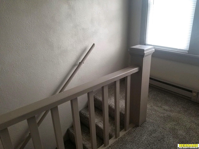 stairway featuring a baseboard radiator