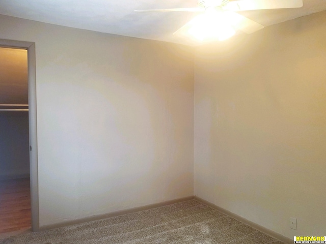 empty room featuring carpet flooring and ceiling fan