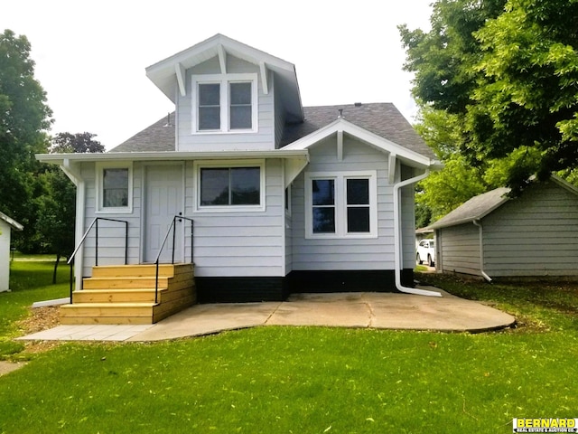 back of house with a lawn