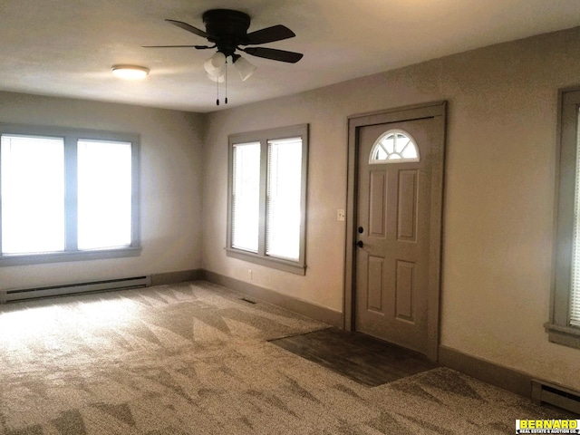 foyer with carpet floors, a baseboard radiator, and ceiling fan