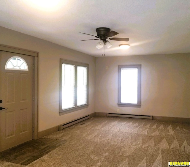 entryway featuring carpet flooring, ceiling fan, and a baseboard radiator