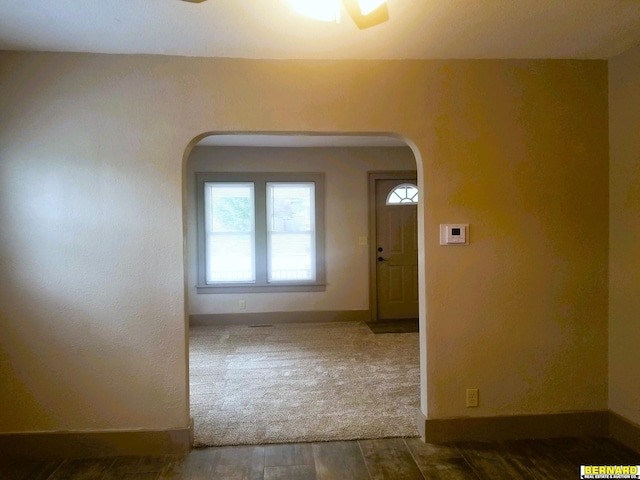 interior space with ceiling fan and dark hardwood / wood-style flooring