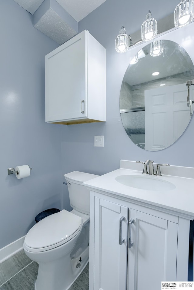 bathroom featuring hardwood / wood-style floors, vanity, toilet, and an enclosed shower