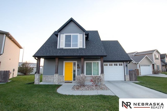 view of front of property with a porch, a garage, and a front lawn