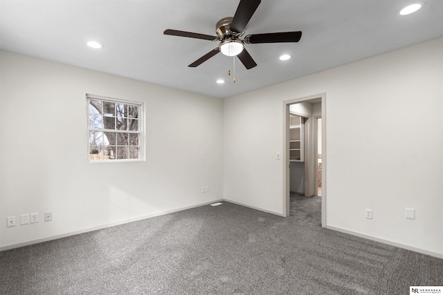 empty room with ceiling fan and carpet floors