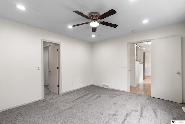 unfurnished bedroom with ceiling fan and light carpet