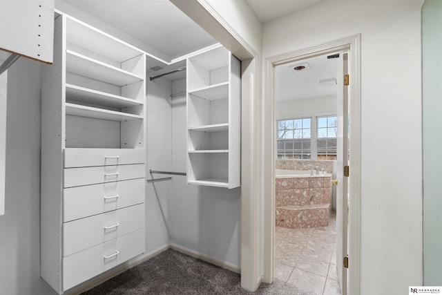 walk in closet with tile patterned flooring