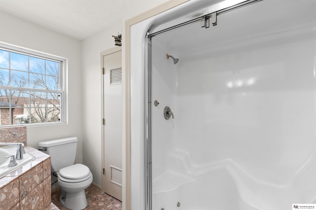 bathroom with a shower and toilet