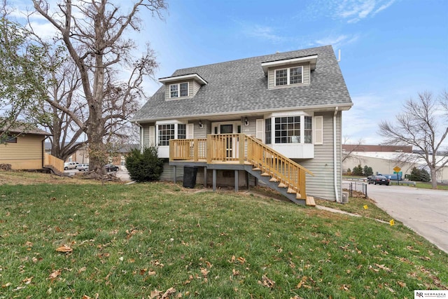 back of property featuring a yard and a wooden deck