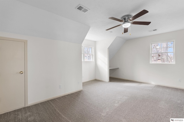 additional living space featuring carpet, ceiling fan, and lofted ceiling