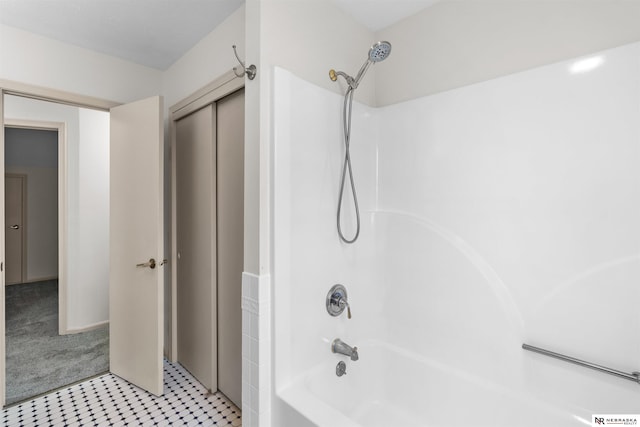 bathroom with tile patterned floors and shower / washtub combination