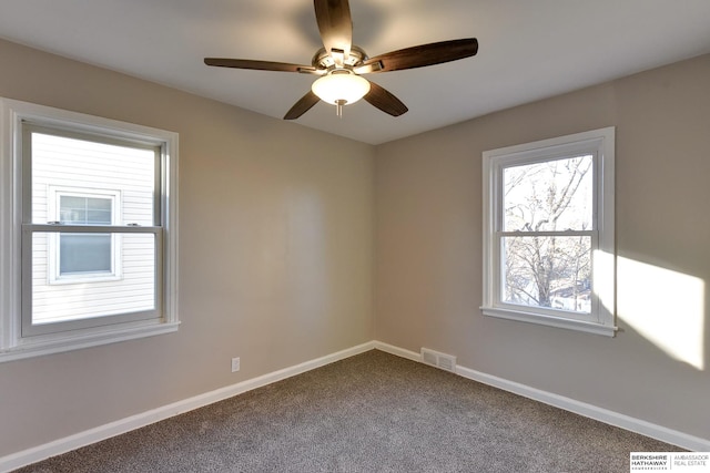 carpeted empty room featuring ceiling fan