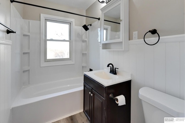 full bathroom featuring vanity, toilet, wood-type flooring, and shower / tub combination