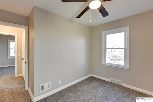 spare room with carpet flooring, plenty of natural light, and ceiling fan