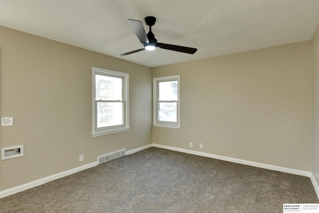 carpeted spare room featuring ceiling fan