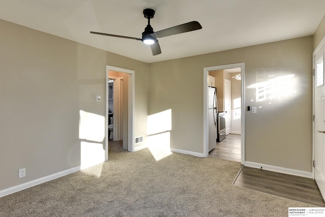 carpeted empty room with ceiling fan