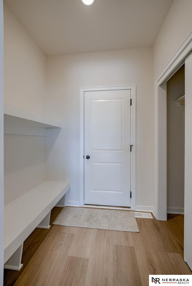 mudroom featuring baseboards and wood finished floors