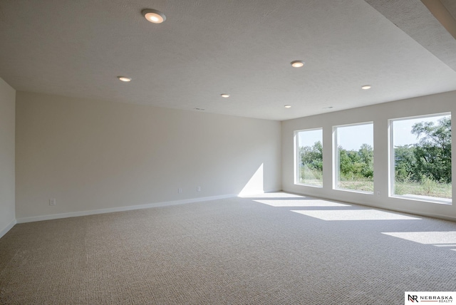 unfurnished room featuring recessed lighting, carpet flooring, and baseboards