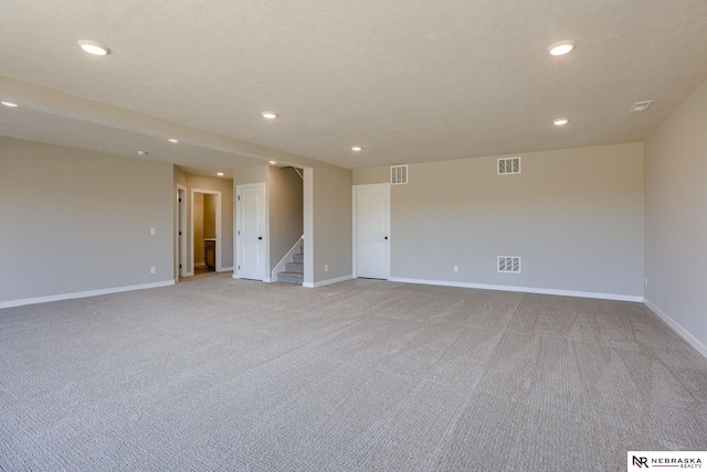 spare room with visible vents, baseboards, and stairs