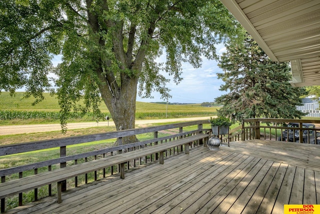 wooden deck with a rural view