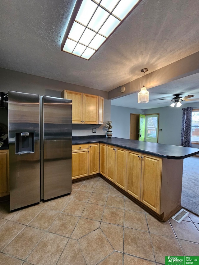 kitchen with stainless steel refrigerator with ice dispenser, ceiling fan, a textured ceiling, decorative light fixtures, and kitchen peninsula