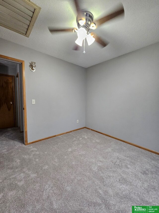 carpeted empty room featuring a textured ceiling and ceiling fan