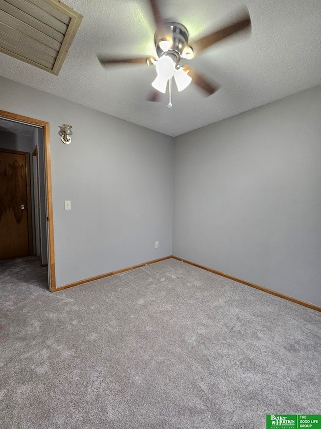 carpeted empty room featuring ceiling fan and a textured ceiling