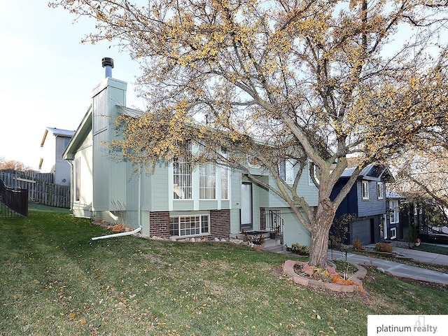 view of front of property featuring a garage and a front lawn