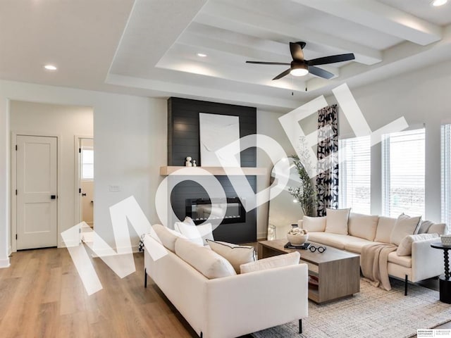 living room featuring ceiling fan and light hardwood / wood-style floors