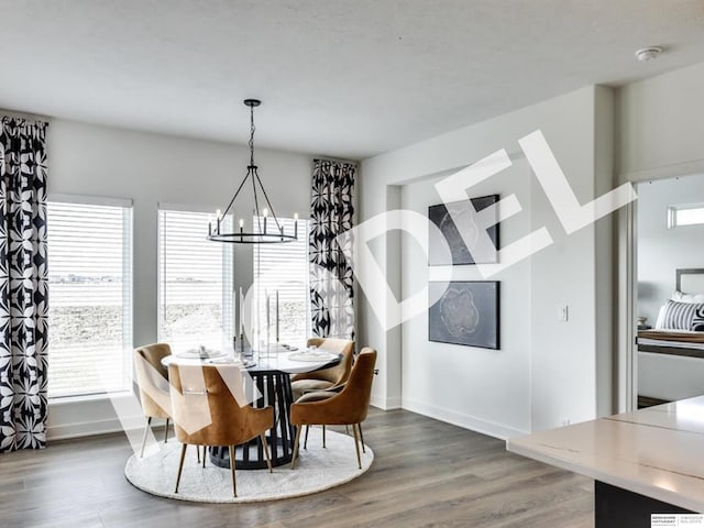 dining space with a chandelier and dark hardwood / wood-style flooring