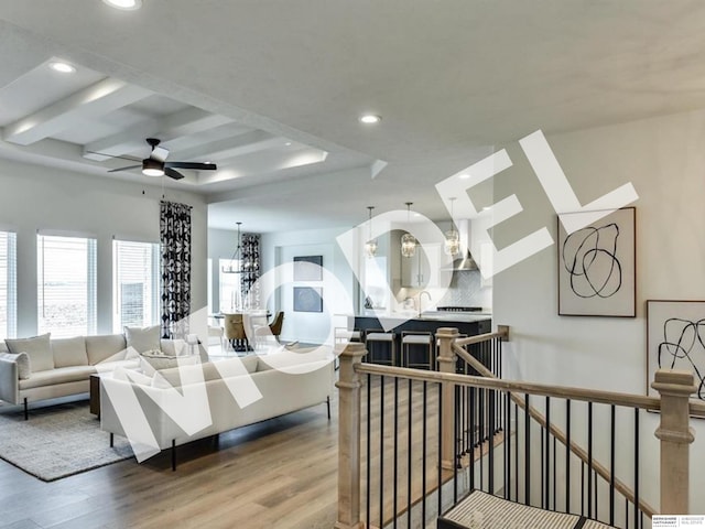 living room with ceiling fan and wood-type flooring