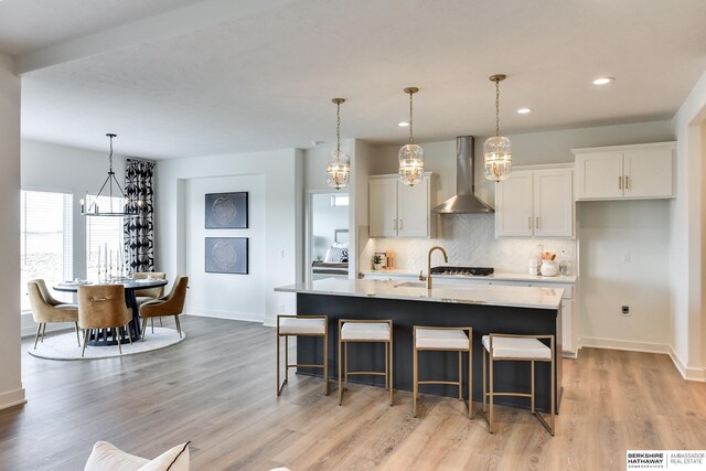 6614 S 200th Ave, Omaha, NE 68135 - living room with a tray ceiling, a chandelier, light wood-style floors, ceiling fan, and recessed lighting