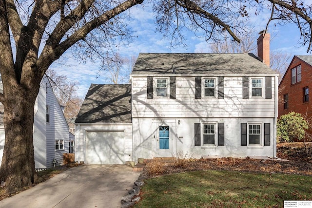 colonial-style house with a garage and a front yard