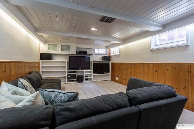 living room with beam ceiling, wooden ceiling, and wooden walls