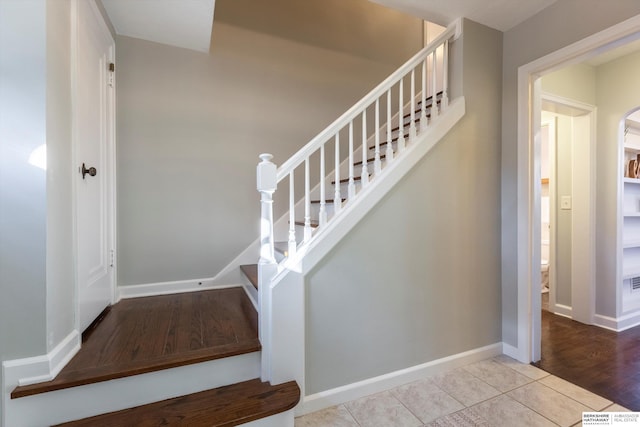 stairway featuring wood-type flooring